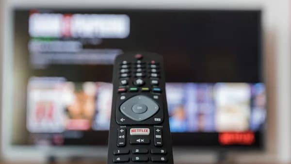black remote control on brown wooden table