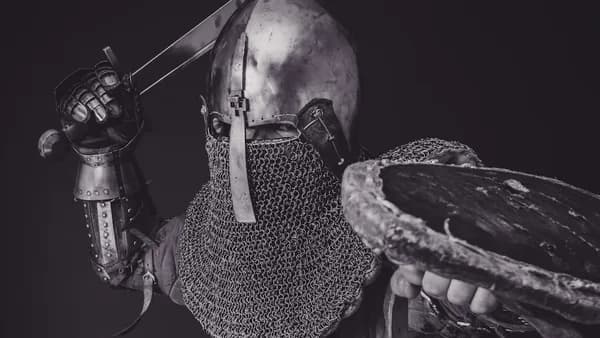 man with steel and chainmail armor holding sword