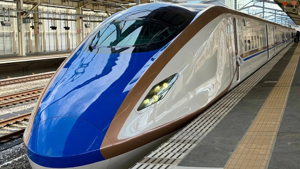 A modern bullet train at a station platform.