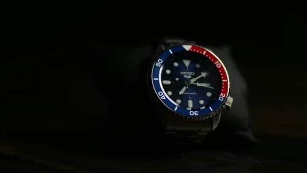 a watch sitting on top of a black table